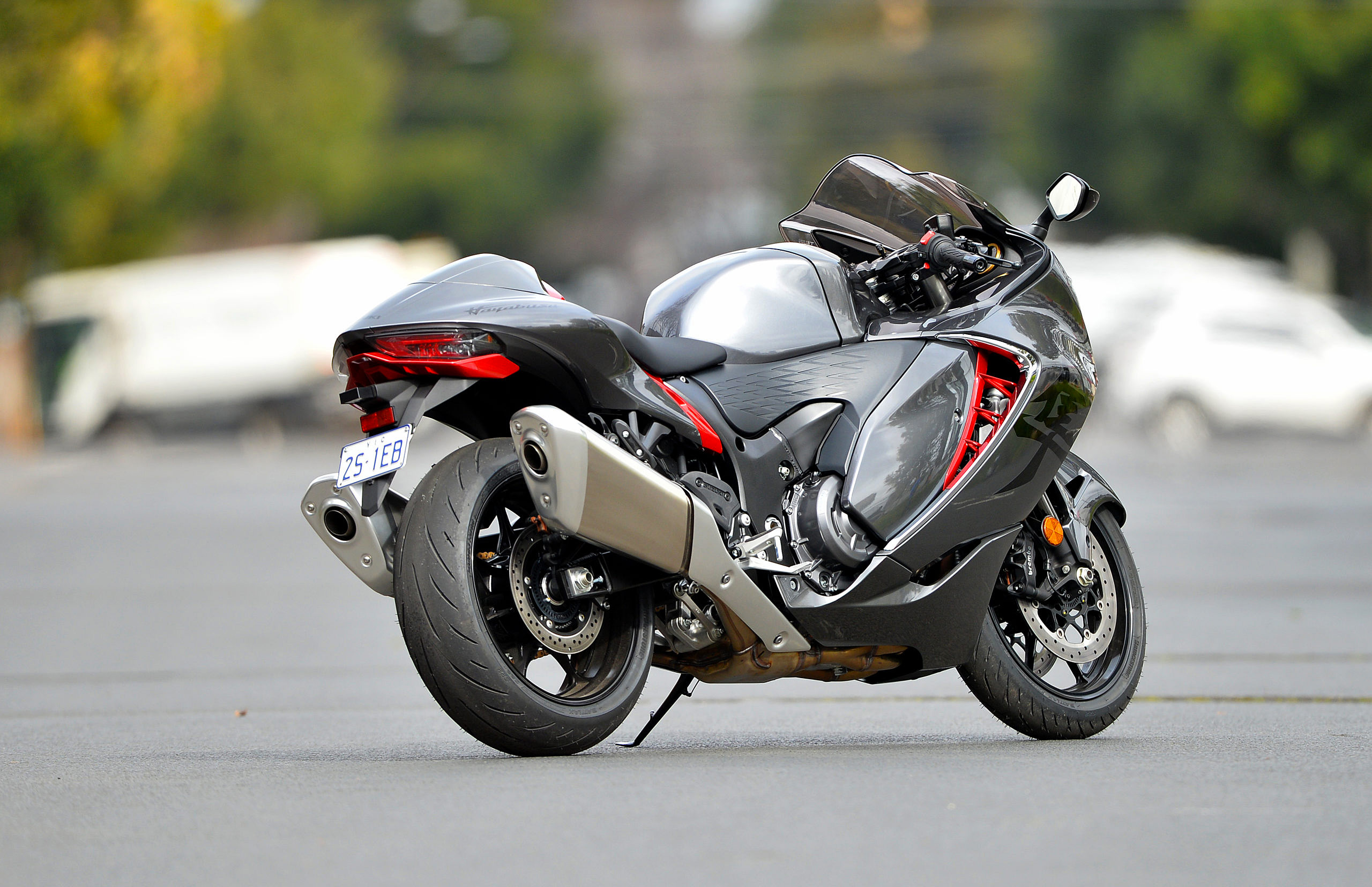 If your intention is to make a splash in the
                motorcycle sphere, one guaranteed way to do it is to set
                a new top-speed benchmark. That’s become increasingly
                difficult in a world with somewhat more conservative
                views on things like speed, but back in 1999 the ability
                of Suzuki’s Hayabusa to consistently bust the 300km/h
                mark was something to be celebrated. Briefly. In the
                sports-tourer speed wars of the time Kawasaki was next
                to come along with the ZX-12R and, in the brief time
                between the release of the two models, an industry
                agreement came into place, limiting top speeds to
                299km/h. The immediate result was that Hayabusas
                subsequently came out with the limiter and a speedo
                marked to ‘just’ 280, with unlabelled increments to 300.
                That in turn has meant collectors are keen on getting
                early Hayabusas with the full 340km/h speedo –
                particularly if they’re the copper-coloured variants
                used in most of the original factory brochures and ads.
                Hayabusa is now in its third generation. In 2008 the
                second-gen boasted a lift in engine capacity from 1299
                to 1340cc, with the power claim going from 130 to a
                hefty 147kW (197hp). It also eventually adopted ABS
                braking. There was some debate over the revised styling
                even if it remained true to the overall theme. As a
                ride, the gen 2 was an improvement, with
                better-developed suspension and significantly better
                brakes. The latter had switched from six- to
                four-spotters on the front and were much sharper. Move
                on to 2021 and the company made some courageous
                decisions. While everyone expected a big new number
                (engine size, power, or both) in fact the engine
                remained at the same capacity while power dropped a
                little to 140kW (188hp), though torque lifted from 139
                to 150Nm. Oh, and the price jumped significantly to
                $28,190. You can imagine the howling on social media.
                Trying to overcome the cacophony, the maker pointed out
                the bike was better finished than ever, was running
                revised engine tuning that emphasized mid-range
                performance, a better chassis and far more sophisticated
                electronics, all of which added up to a quicker real
                world machine. Every area of the machine came in for
                revision. As an example, while the machine was still
                running Kayaba suspension front and back, the internals
                had come in for significant retuning, the effects of
                which were noticeable for anyone who had the chance to
                sample earlier models. Also upgraded are the brakes, now
                with 320mm discs up front and Brembo Stylema four-spot
                radial-mount calipers. As for the engine, the entire
                breathing has been revised with new airbox, injectors
                and exhaust. Electronics now abound, starting with the
                ride-by-wire throttle. Then there are six overall ride
                modes available – three preset and three customized –
                different modes for traction control, wheelie control,
                engine braking and launch control. All of this is tied
                to a Bosch six-axis Inertial Measurement Unit, which is
                central to the cornering ABS. Still, there has been
                plenty of shouting about no new big horsepower figure.
                Of course, this is the risk when you develop a model
                line that’s effectively become a cult bike – people
                develop some passionate views that things like logic may
                never shift. Perhaps a ride, then? I own a
                first-generation Hayabusa and have had a few rides on
                the second, so was more than a little curious to throw a
                leg over the new toy. The first thing that hits you is
                the level of finish and presentation is several steps up
                from that of its predecessors. Little design ‘easter
                eggs’ are dotted around the machine and it’s clear
                someone has gone to a lot of trouble to make you feel
                good about it. That helps to take some of the pain out
                of the higher price. Meanwhile, it has a bunch of new
                features that have an immediate effect on how you ride,
                such as the cruise control and a two-way powershifter.
                That first feature alone would make me look at it in a
                different light. The end result of all this is a
                motorcycle that feels tractable and trustworthy. It’s
                unquestionably a better ride than its predecessors when
                it comes to steering (light and sharp) and suspension.
                Performance? It’s unlikely you would notice any deficit
                – it’s fearsomely fast when you want it to be, with a
                mid-range that you feel like you could surf forever and
                still get where you’re going at a hair-raising rate. We
                wonder if this might be the final Hayabusa generation.
                There’s no indication of that from Suzuki, but when you
                look at how the transport landscape and motorcycle
                market are changing, it has to be considered a
                possibility. Regardless, having all three generations in
                the shed is a very attractive possibility for the
                collector. In the meantime, the latest-gen is easier to
                ride with a level of confidence the predecessors can’t
                match and certainly deserving of the Hayabusa name. Pipe
                dreams Our demo bike was running a four-into-one
                Akrapovic aftermarket exhaust system (above), rather
                than the four-into-two stocker (below). It had a more
                fruity note and was lighter by around 14kg, according to
                the maker. We’ve seen dyno charts that suggest a lift in
                power (up to 6.5kW) and torque (up to 5.7Nm) with the
                aftermarket unit once the correct mapping is in place.
                Good Quick Good handling Well-finished Not so good
                Significant price jump SPECS Gen 3 Suzuki Hayabusa
                ENGINE TYPE: liquid-cooled, four-valves-per-cylinder,
                inline four CAPACITY: 1340cc BORE & STROKE: 81 x
                65mm COMPRESSION RATIO: 12.5:1 FUEL SYSTEM: EFI
                TRANSMISSION TYPE: Six-speed, constant-mesh FINAL DRIVE:
                Chain CHASSIS & RUNNING GEAR FRAME TYPE: Aluminium
                twin-spar FRONT SUSPENSION: 43mm USD fork, full
                adjustment REAR SUSPENSION: Monoshock, full adjustment
                FRONT BRAKE: twin 320mm discs, 4-piston caliper with ABS
                REAR BRAKE: single-piston caliper with ABS DIMENSIONS
                & CAPACITIES WET WEIGHT: 264kg SEAT HEIGHT: 800mm
                WHEELBASE: 1480mm FUEL CAPACITY: 20lt TYRES FRONT:
                120/70-17 REAR: 190/50-17 PERFORMANCE POWER: 140kW
                (188hp) @ 9700rpm TORQUE: 150Nm @ 7000rpm HIGHWAY FUEL
                USE: approx 16km/lt OTHER STUFF PRICE $28,190 on the
                road WARRANTY 2 years unlimited km